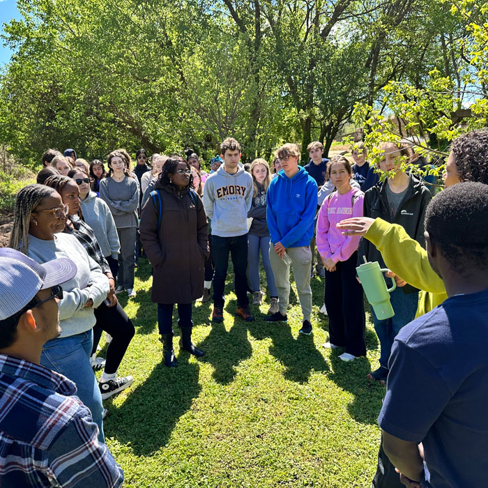 a group of students standing in a circle outside