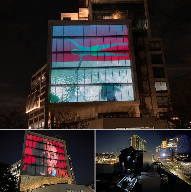images of a swimmer and a man's face projected onto buildings at night; a technician on a rooftop operating a projector